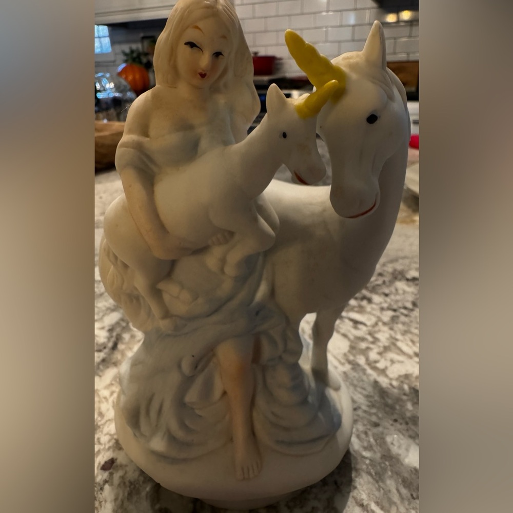 This is a vintage Arimark musical figurine of a woman and two unicorns.